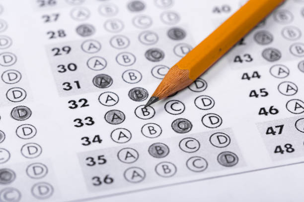 istock testing in exercise and exam paper. computer sheet with pencil in school test room, education concept 1198462544