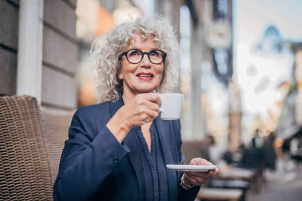 istock Beautiful senior woman drinking a hot drink 1198462567