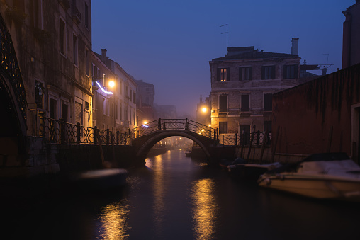 Venetian gondolas moored on a winter fogy morning
