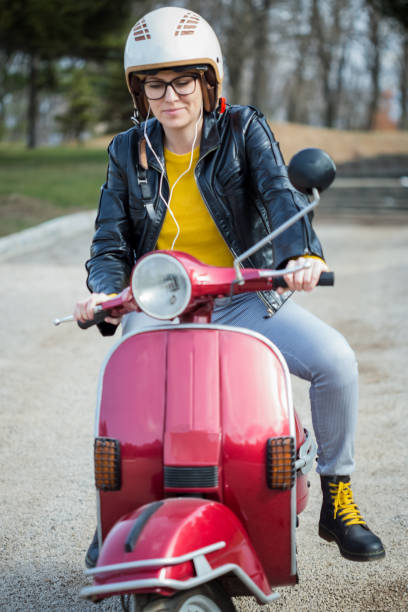 istock Young Woman Riding Motor Scooter 1198469546