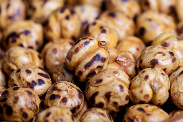 Roasted and dry chickpeas in a bowls on wooden table.