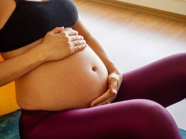 istock Pregnant woman doing pilates exercises 1198471582