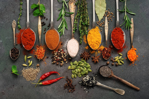 istock A variety of spices, herbs, seeds in a spoon on a dark painted rustic background. Assorted colored different seasonings. Flat lay,overhead. 1198475346
