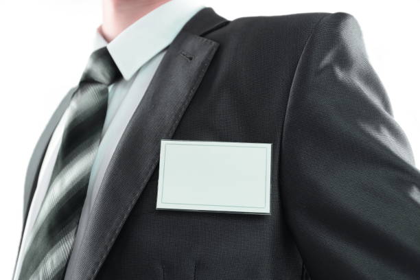 istock Blank identity tag hanging from a businessmans suit 1198475525