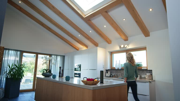 Lights turning on while woman entering kitchen