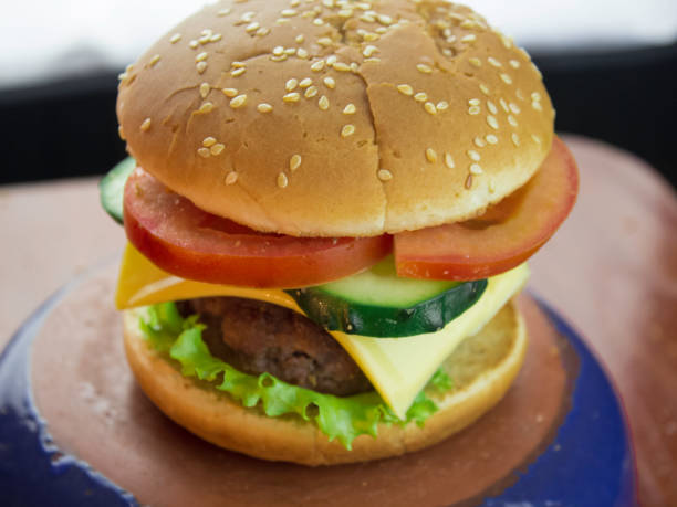 istock Big juicy burger with beef cutlet, fresh vegetables and melted cheese. 1198476721