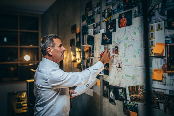 istock Mature detective examining evidences 1198476727