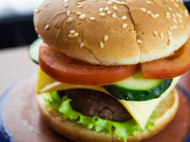 istock Big juicy burger with beef cutlet, fresh vegetables and melted cheese. 1198476736