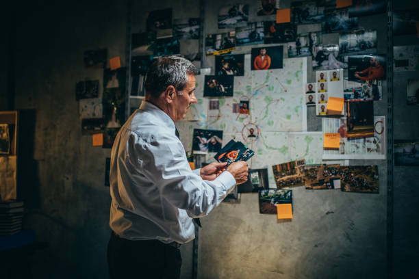 istock Mature detective examining evidences 1198476766