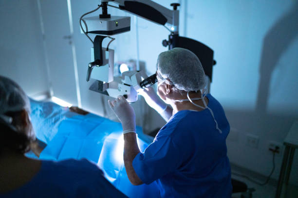 Doctor doing eye surgery of patient in hospital Doctor doing eye surgery of patient in hospital eye surgery photos stock pictures, royalty-free photos & images