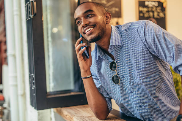 istock Man in coffee shop using phone 1198477888
