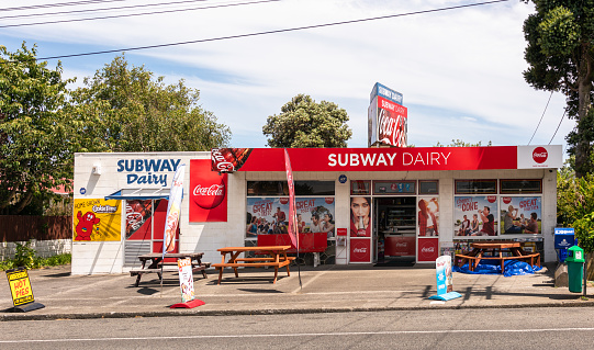 Hawera, New Zealand - A dairy store in the town of Hawera, with advertising on the exterior of the shop.