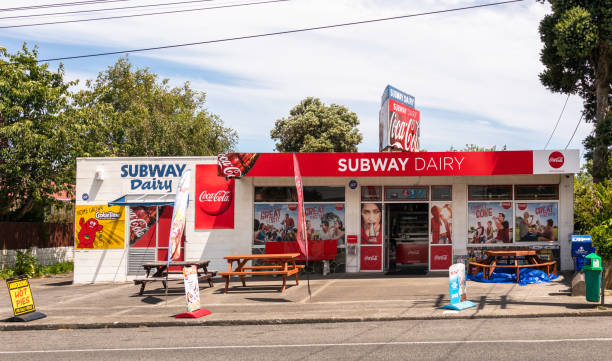 Typical dairy shop in New Zealand Hawera, New Zealand - A dairy store in the town of Hawera, with advertising on the exterior of the shop. mini kiwi stock pictures, royalty-free photos & images