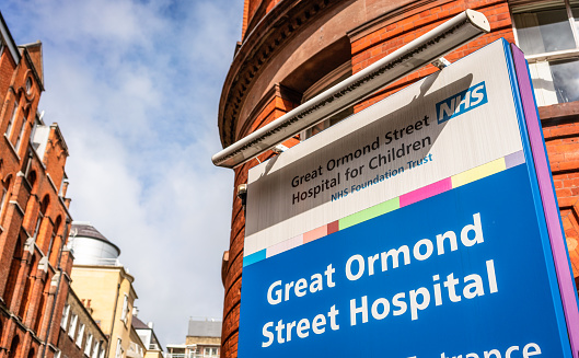 London, UK - A sign by the street entrance of the Sign for Great Ormond Street Hospital for Children, an NHS hospital in London.