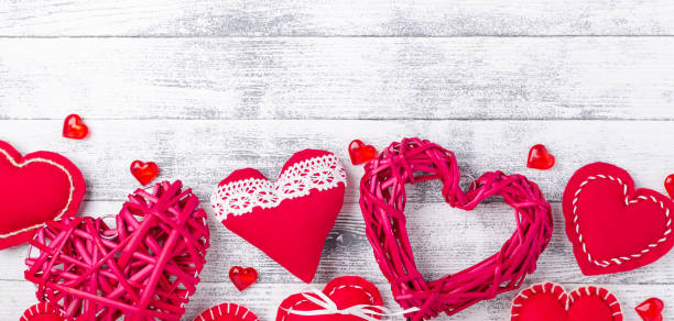 Red hearts on wooden white background. The concept of Valentine Day. Copy space for your text Red hearts on wooden white background. The concept of Valentine Day. Copy space for your text - Image book heart shape valentines day copy space stock pictures, royalty-free photos & images