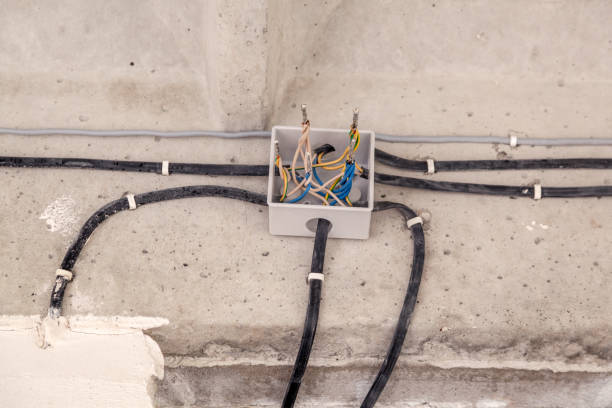 istock Cable laying ceiling. Electrical wires on wall. Wiring replacement. Connecting light in flat or office. Professional installation bulb, electrical outlet, cable, wires, switches. Insulation 1198479907