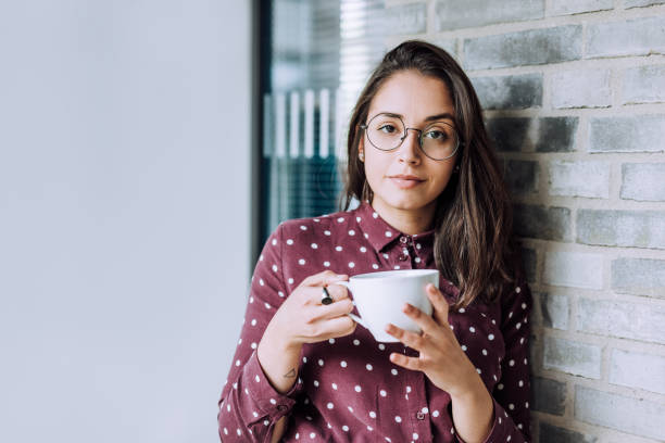 istock businesswoman relaxing at work with a hot beverage 1198479932
