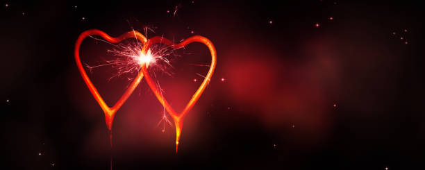 istock two burning heart shape sparkler at romantic night 1198481212