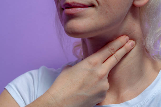 istock A woman measures the pulse on her neck. 1198483895