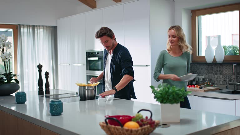 Man using smart device while cooking food at home