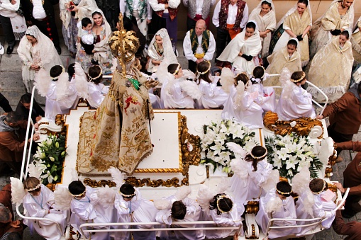 Elche, Alicante, Spain- December 29, 2019: Virgin of the Assumption accompanied by parishioners in procession for the streets of Elche for its festivity