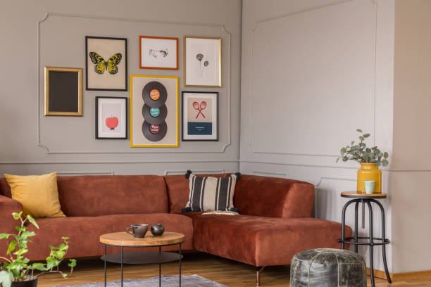 istock Elegant coffee table in front trendy sofa in modern living room interior with grey wall 1198487829