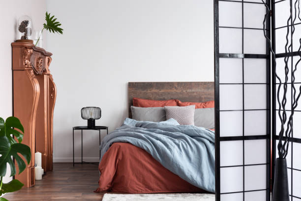 istock Copy space on empty white wall of rustic bedroom interior 1198488512