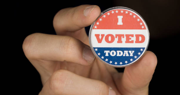 istock Macro shot of I Voted Today button in holding in hands 1198488831