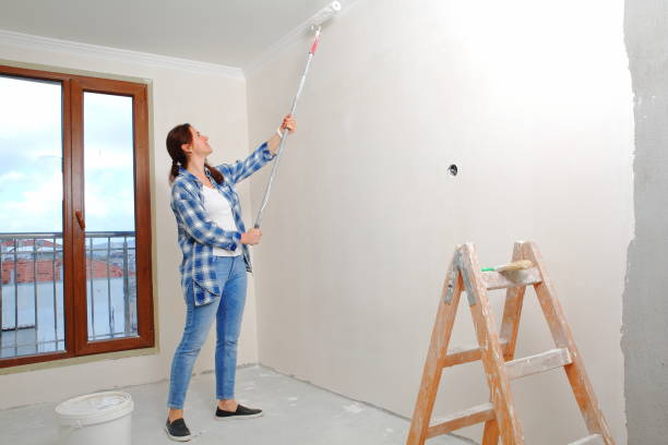 istock Woman paint on wall 1198489019
