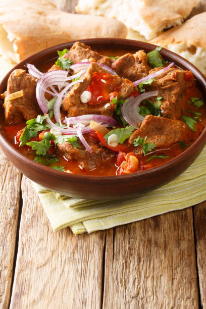 istock Spicy Georgian Beef Stew Chashushuli Ostri close-up in a bowl. vertical 1198489832
