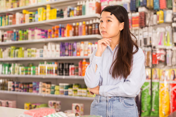 istock Asian woman in cosmetics store 1198493352