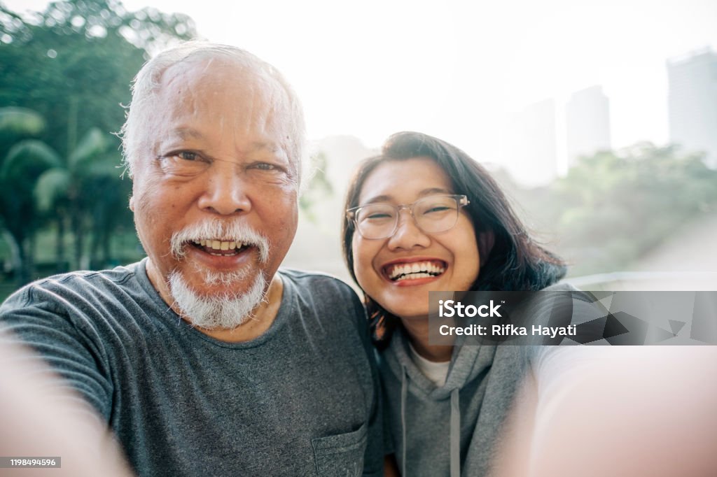 Lovely Senior Father and Daughter Taking Selfie Together Senior healthy living lifestyle Father Stock Photo