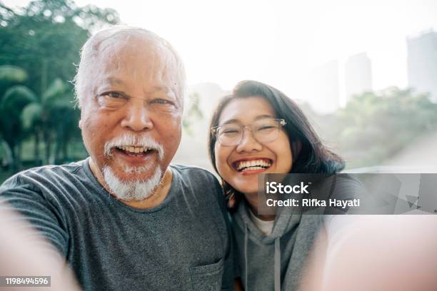 Lovely Senior Father And Daughter Taking Selfie Together Stock Photo - Download Image Now