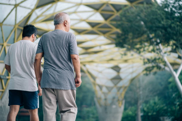 istock Lovely Asian Father and Son Jogging Together 1198495905