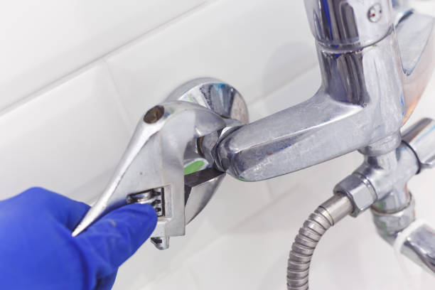 istock Plumber uses pipe wrench for service shower mixer tap 1198498272