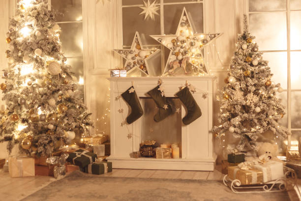 istock Christmas stocking hanging from a mantel or fireplace, decorated for Christmas with fire glowing. 1198498289