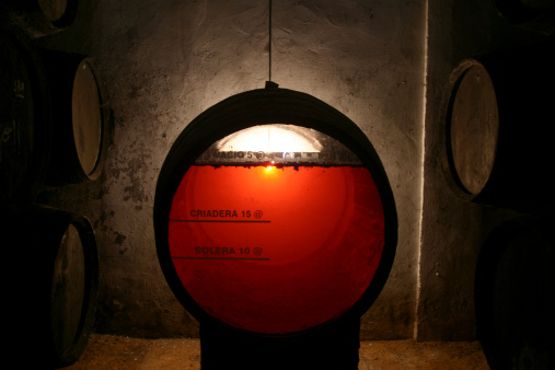 Close-up of oak barrel with metal hoops at the workshop