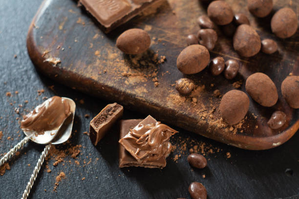 istock Various sweets and chocolate with cocoa powder on a dark wooden surface 1198499360
