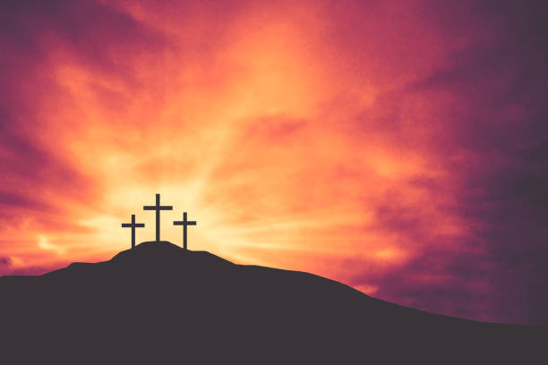 istock Three Easter Crosses on Hill of Calvary with Bright Shining Light and Clouds Background 1198501124