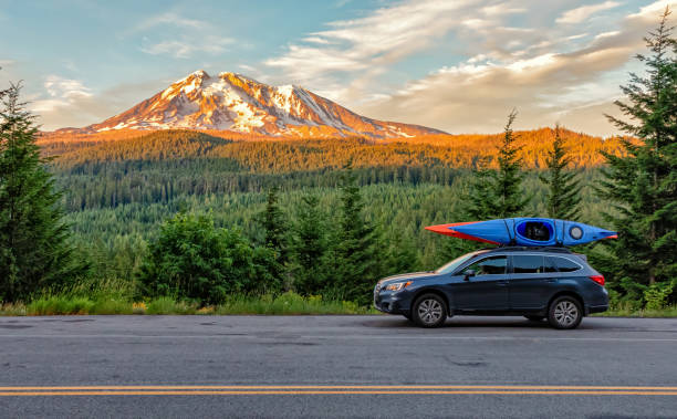 Subaru with Kayaks Gifford Pinchot National Forest, Washington - July 13, 2018:  SUV with Kayaks in front of Mt. Adams at sunset cascade range photos stock pictures, royalty-free photos & images
