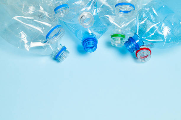 istock Crumpled plastic bottles on a blue background. Plastic trash. Copy space for text. 1198503533