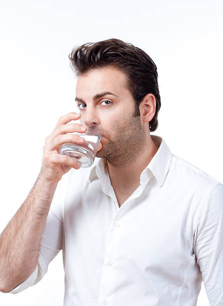istock man holding glass of water 119850381