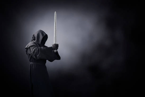 istock Ghostly figure with medieval sword in the dark 1198503931