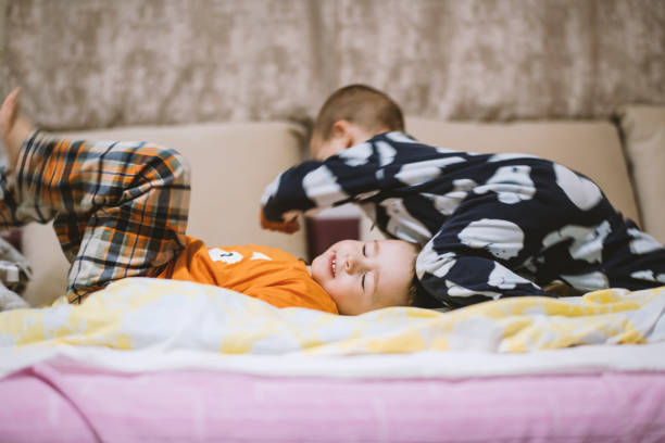 Kids playing in parents bed