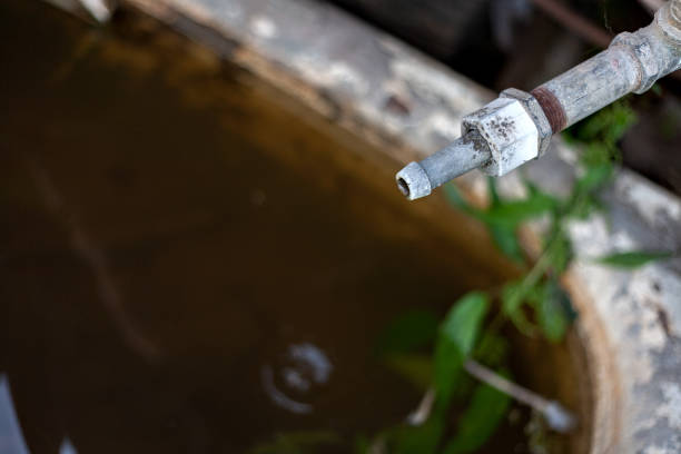 istock old rusty water tap with falling water drop, water shortage concept 1198504803