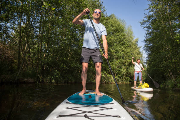 istock Couple on stand up paddle board on the lake, SUP 1198504998