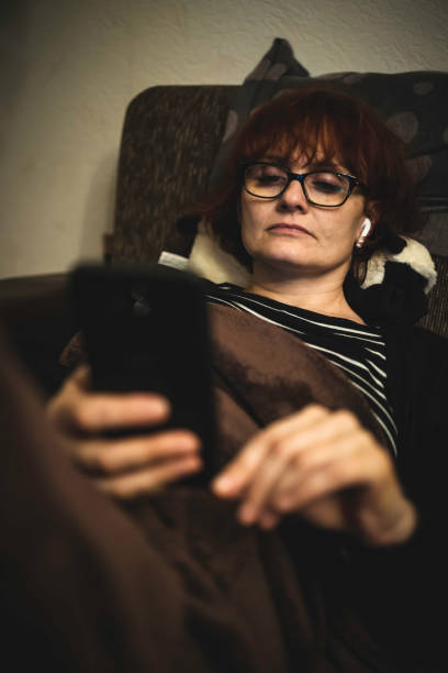istock a woman using smartphone at home 1198505076