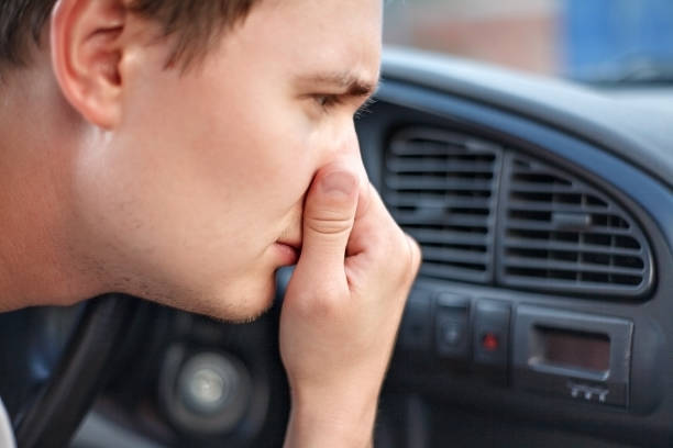 the driver held his nose from the bad smell , air conditioner heating, the concept of faulty air conditioners, bad smell and car - car air conditioner vehicle interior driving imagens e fotografias de stock