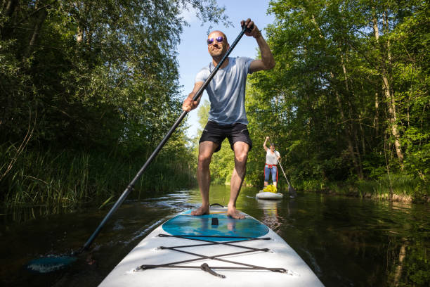 istock Couple on stand up paddle board on the lake, SUP 1198505861