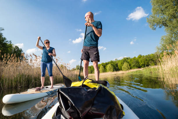 istock Couple on stand up paddle board on the lake, SUP 1198505871